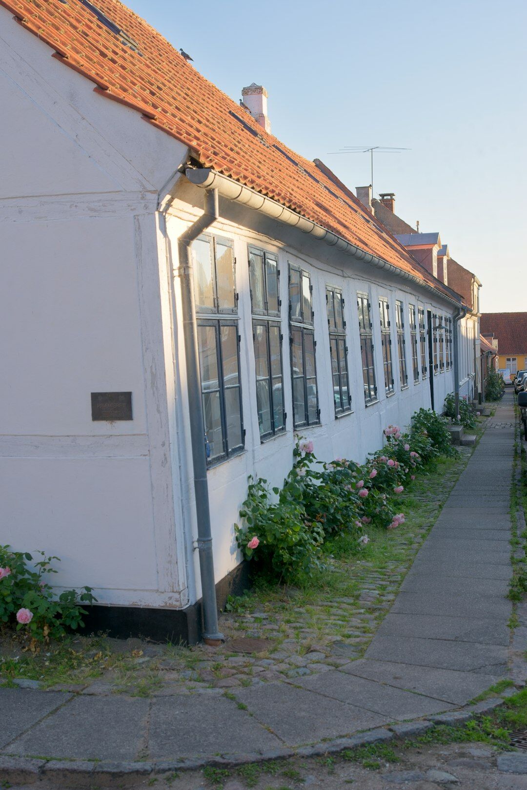 Children playing on a quiet cobblestone street in a small Danish town
