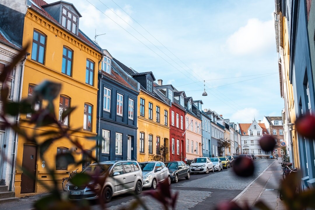 Documentary photographer reviewing photographs on a camera in a small Danish town