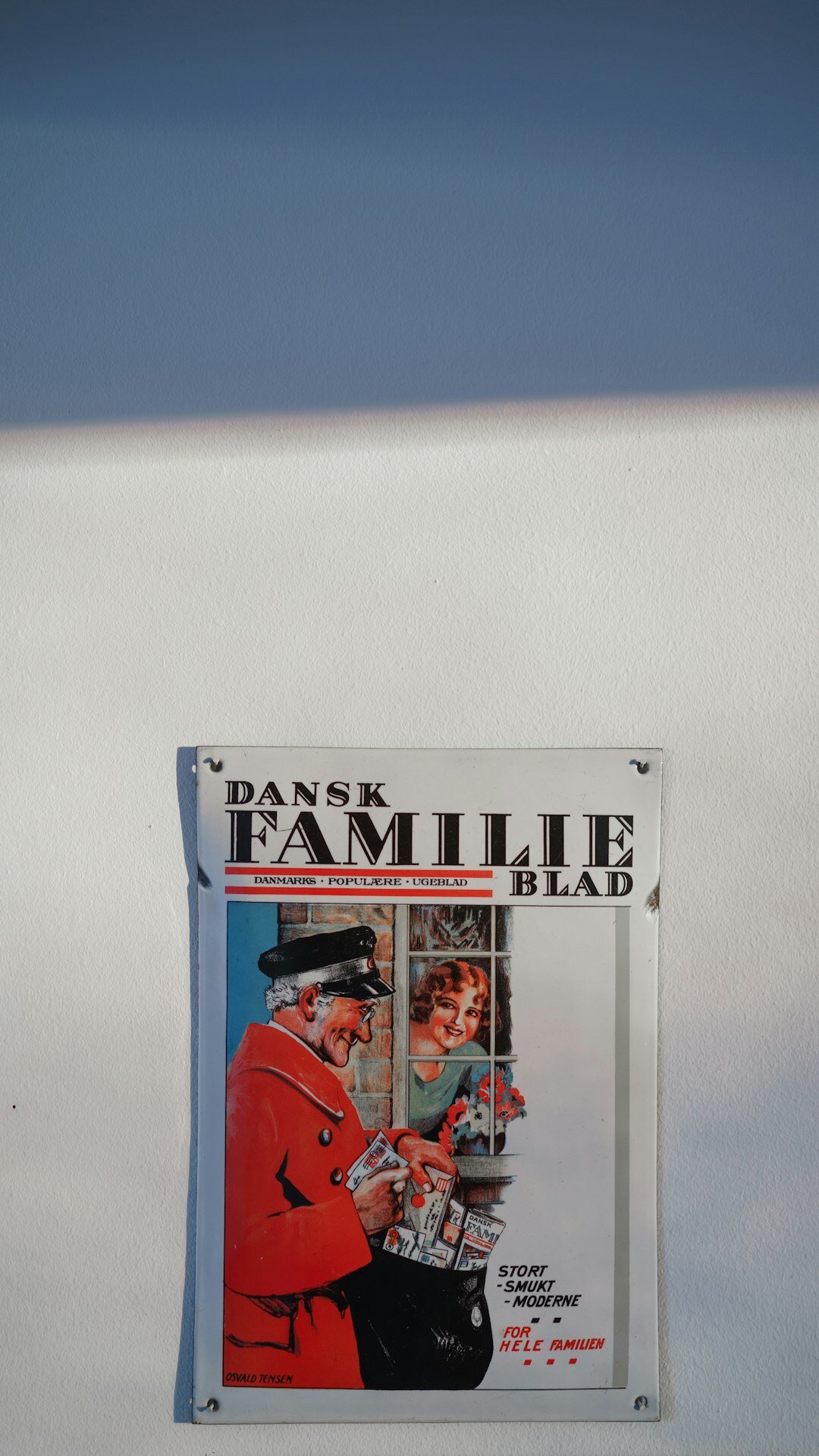 Three generations of a Danish family sitting together at their farmhouse kitchen table