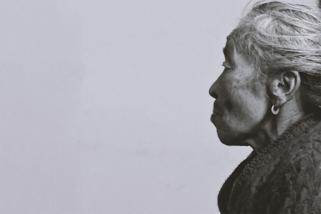 Portrait of an elderly Danish woman standing in her doorway