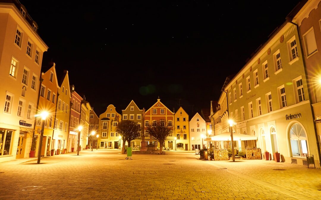 Small Danish town square at night with warm lit windows and empty streets